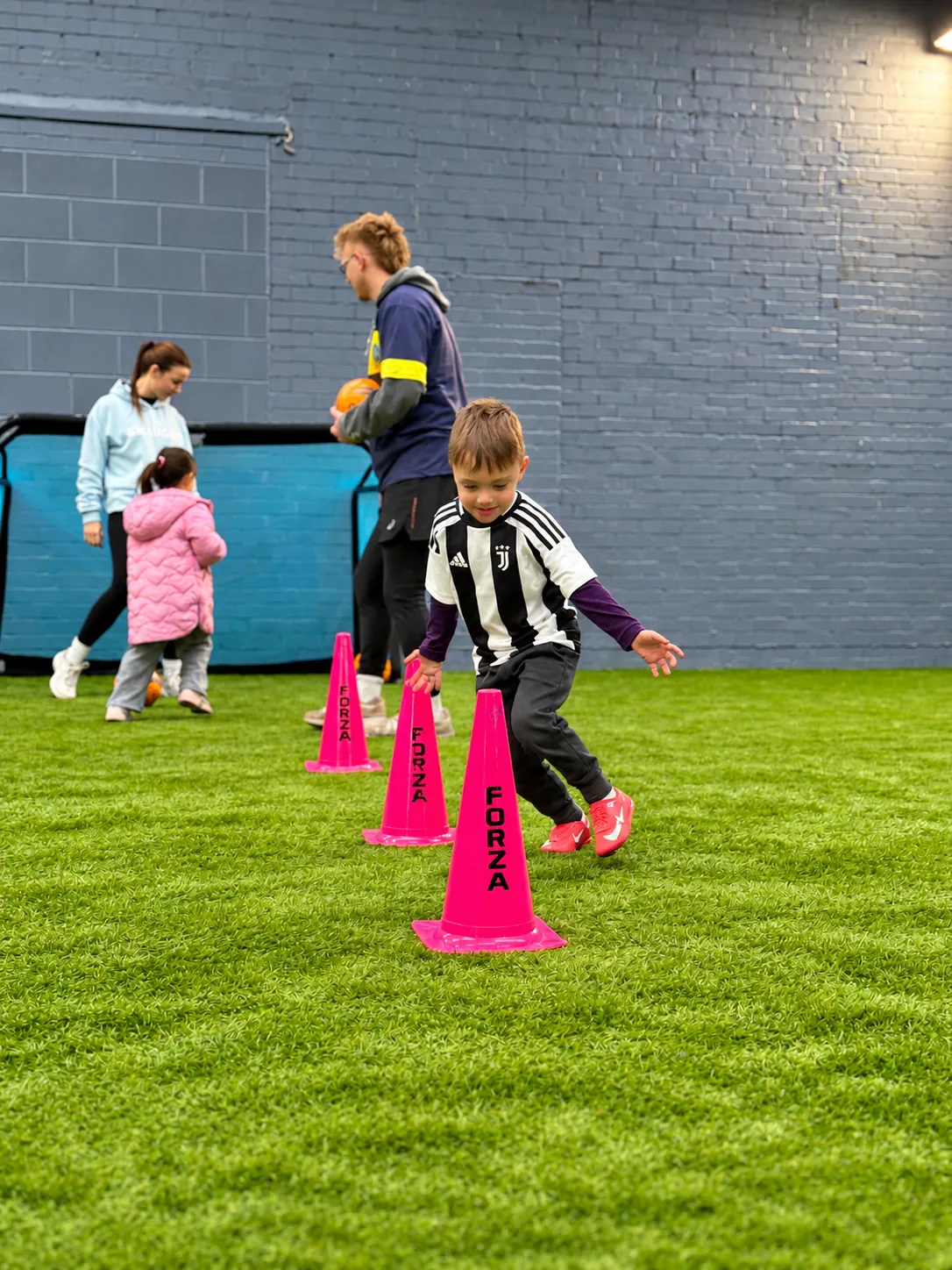 Child running between cones during an Ickle Skills football session