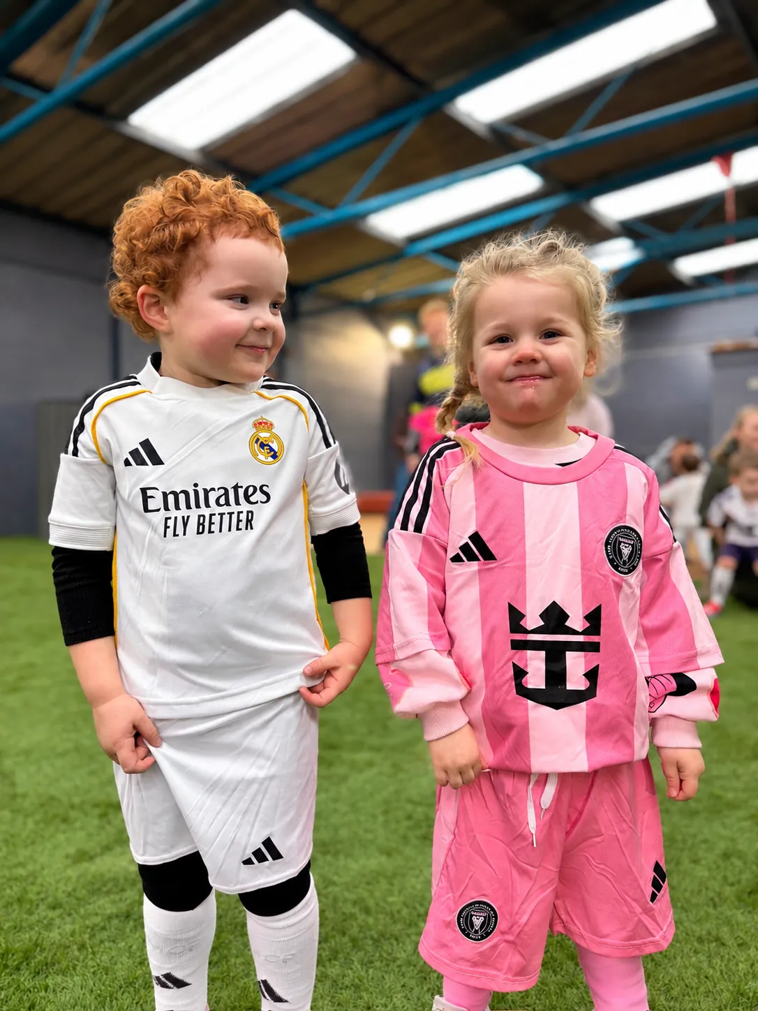 Two young children in football kits standing together at an Ickle Skills session in Poulton-le-Fylde
